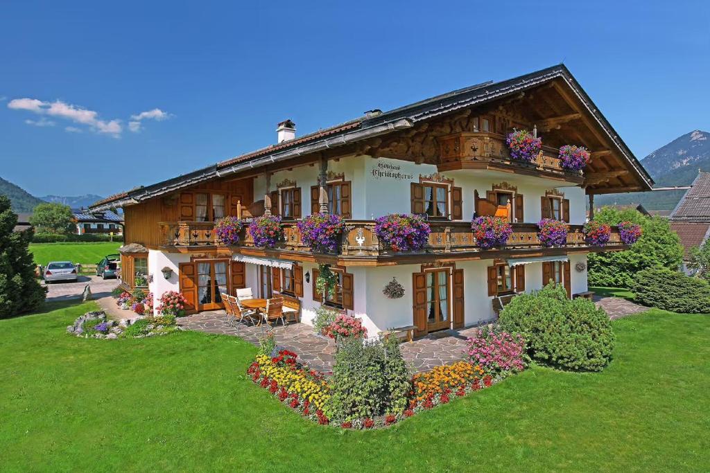 a house with flower boxes on the front of it at Gästehaus Christophorus Adlerhorst in Krün