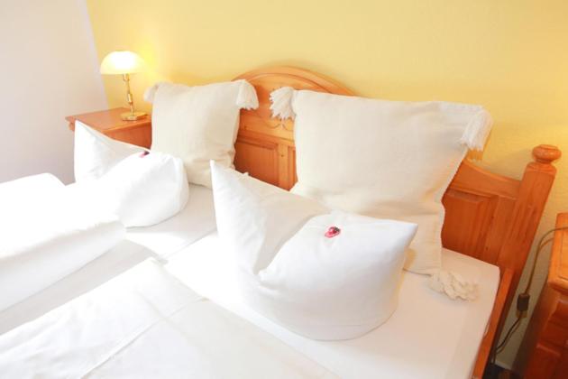 Postel nebo postele na pokoji v ubytování Hotel in der Mühle