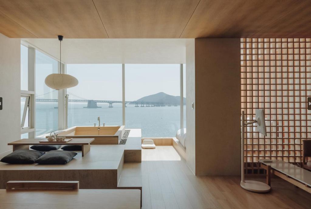 a bathroom with a view of the water and a tub at Onyouji Stay in Busan