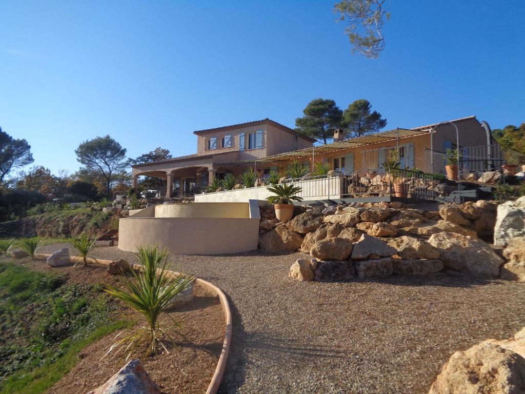 a house with rocks in front of it at BELLA VISTA 1 chambre d&#39;hôtes 2 personnes in Salernes