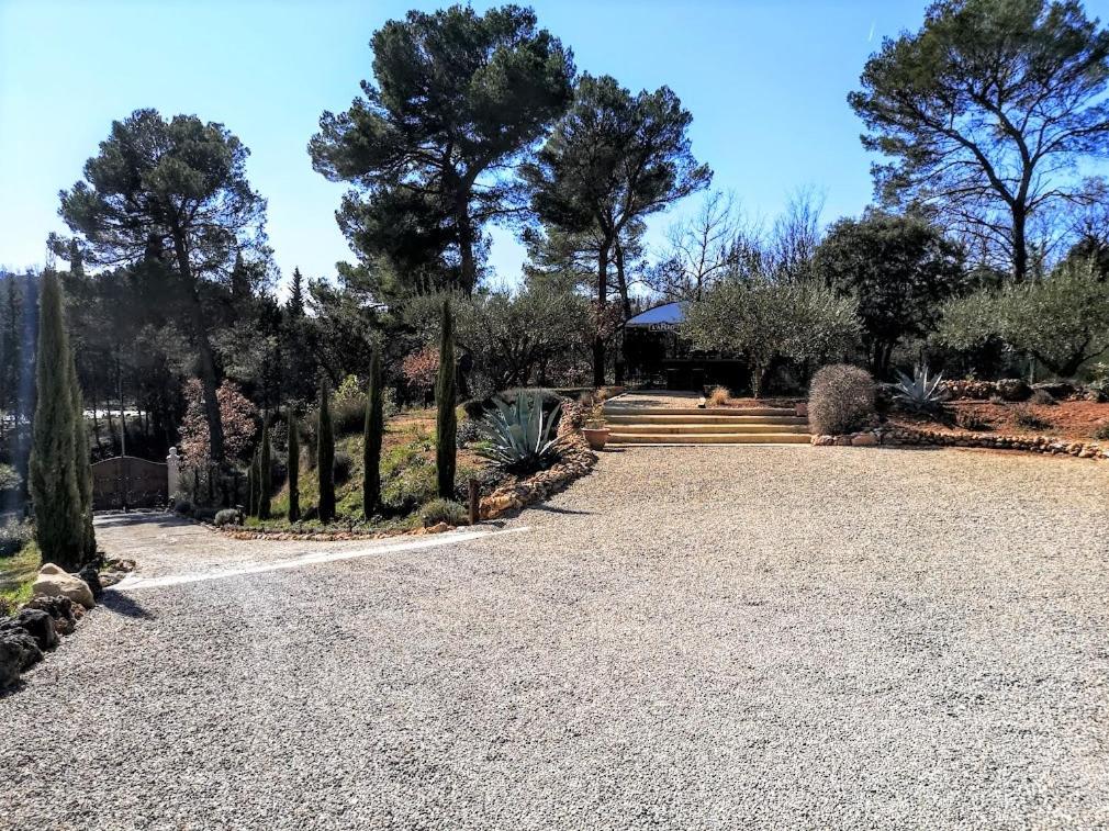 a gravel driveway with trees and stairs in a park at BELLA VISTA 1 chambre d&#39;hôtes 2 personnes in Salernes