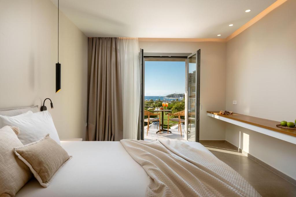 a hotel room with a bed and a balcony at Sofibel sivota suites in Syvota