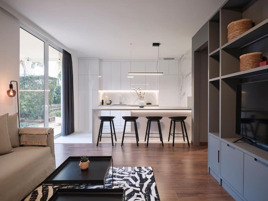 a kitchen and living room with a couch and a table at Serene retreat in Glyfada in Athens