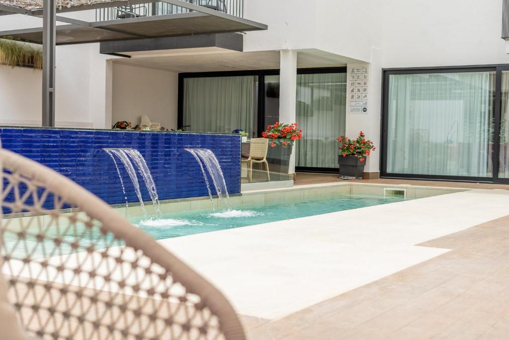 a swimming pool in a building with a house at Neptuno Apartments in Calella