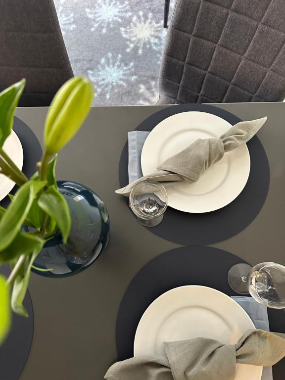 a table with a plate with a hat and a plant at ApartHotel Faber in Aarhus