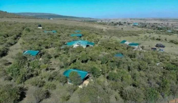 an aerial view of a field with blue roofs at kubwa mara safari lodge tent camp in Sekenani
