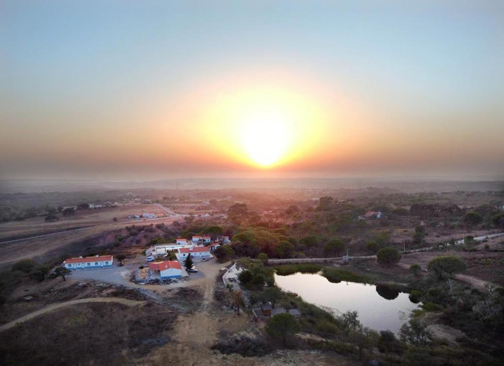 an aerial view of a village at sunset at Monte Sardinha in Santiago do Cacém