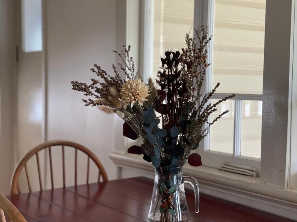 a vase filled with flowers sitting on a table at VG’s BnB in Longreach