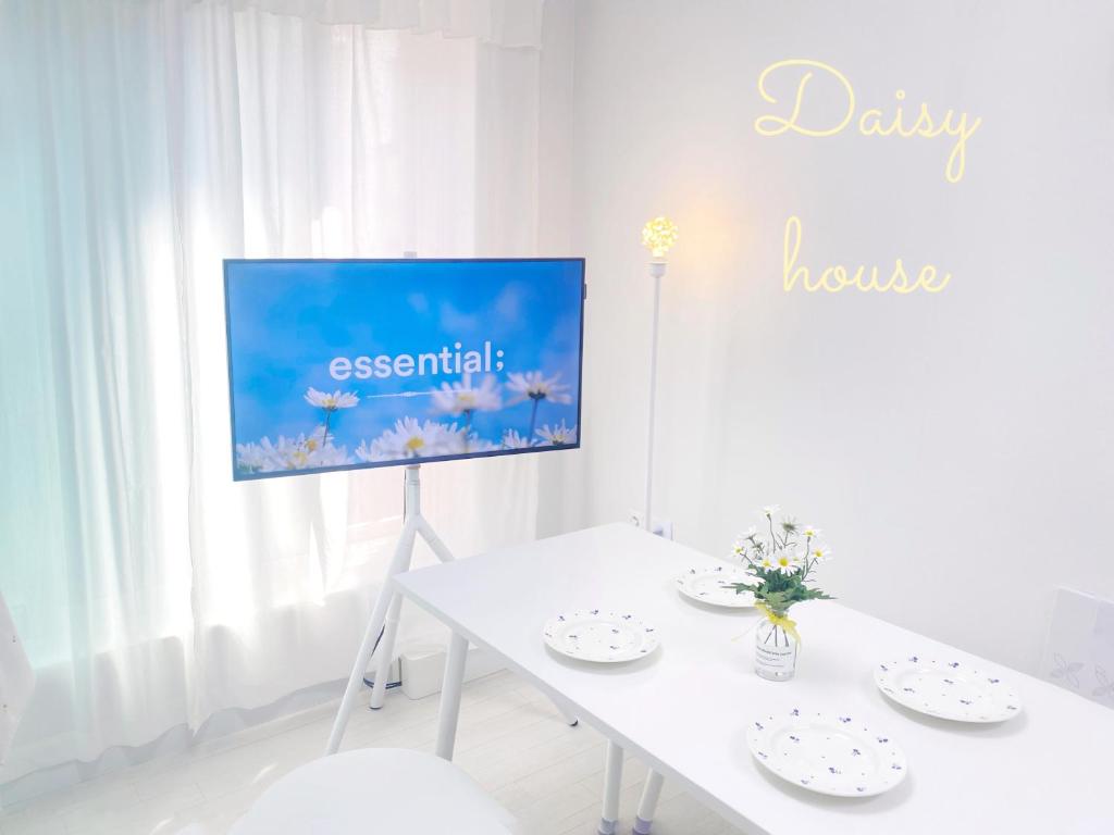 a white dining room with a white table and a tv at 2Room Jamsil lotteworld Kspo dome Olympic Park 2Queenbed in Seoul