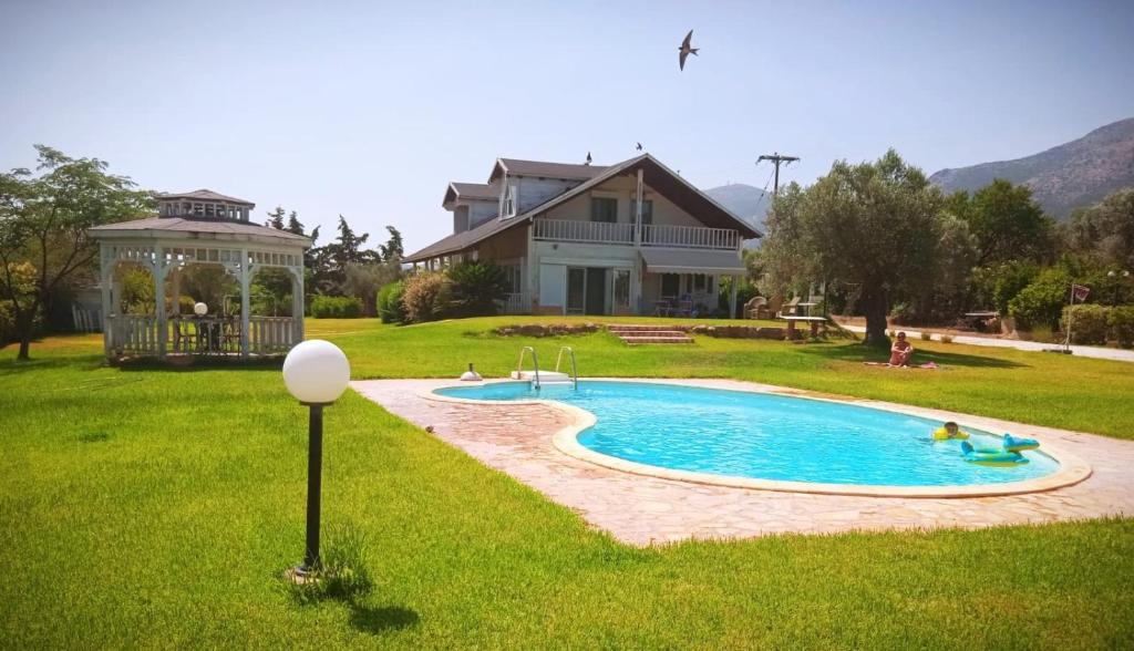 a house with a swimming pool in the yard at Farmhouse with pool minutes from beach in Amarinthos
