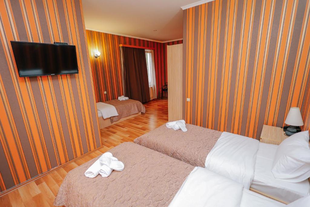 Postel nebo postele na pokoji v ubytování Hotel Darchi