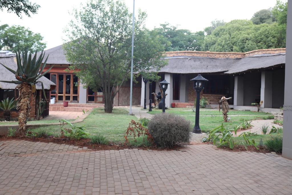 a building with a brick walkway in front of a building at Umnotho We Afrika House in Bronkhorstspruit