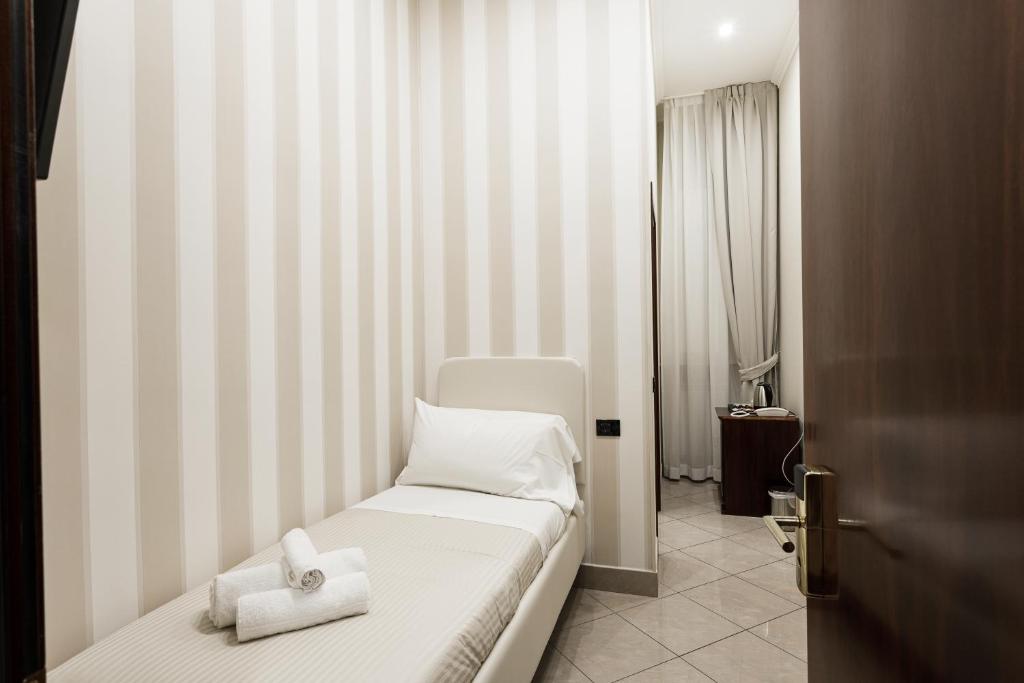 Postel nebo postele na pokoji v ubytování Monti 66 Hotel