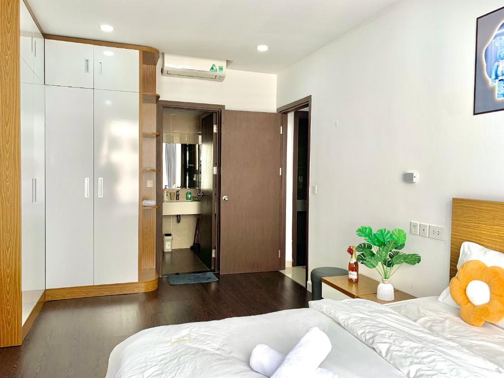 a bedroom with a large bed and a bathroom at Golden Apartment in Ho Chi Minh City