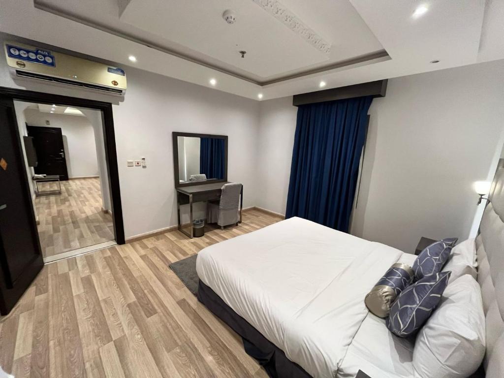 Postel nebo postele na pokoji v ubytování عماره هوليداي المروة- Holiday Al Marwa Building