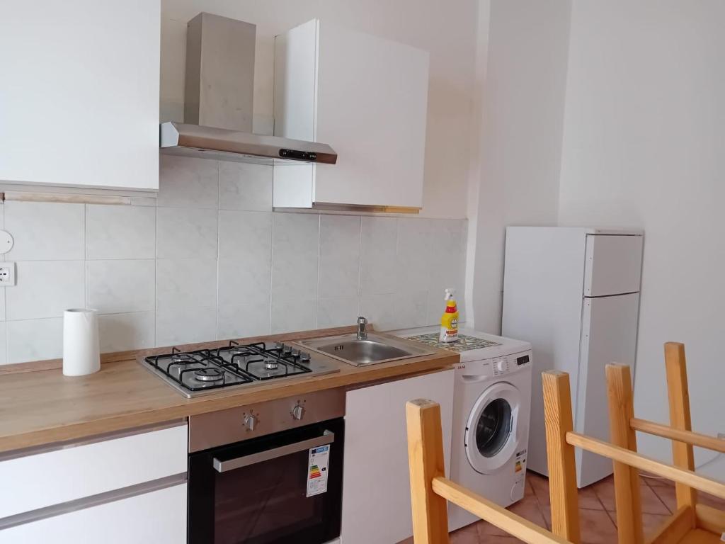 a kitchen with a sink and a washing machine at LoVe House - Apartment on the beach in Pescara