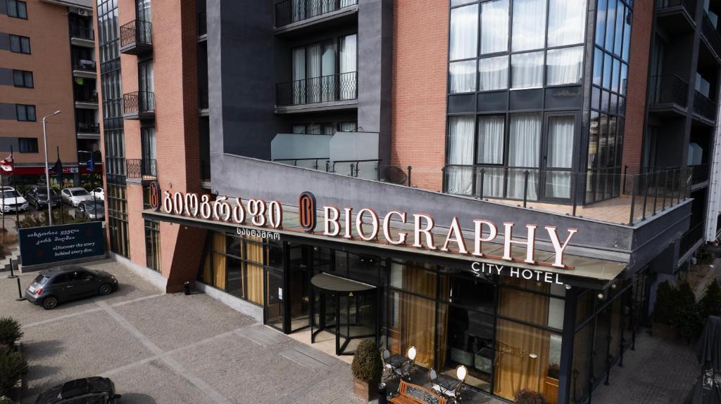 a building with a sign for a grocery store at Biography Design Tbilisi in Tbilisi City