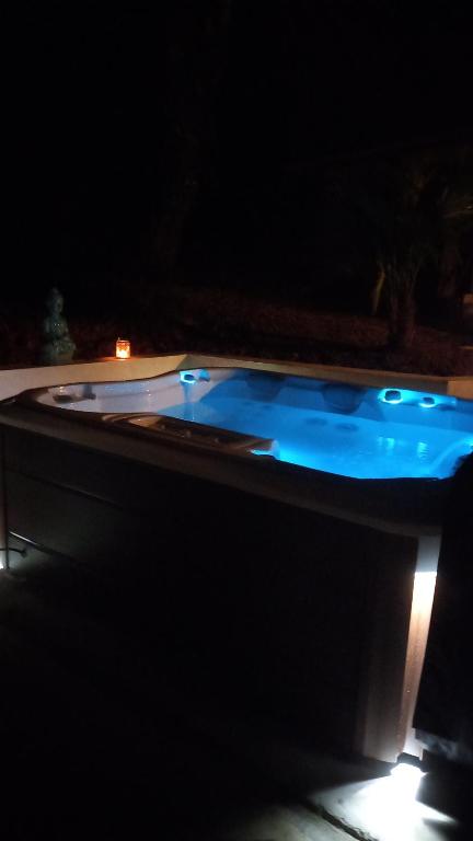 a swimming pool at night with a light on it at Le chant des oiseaux in Cambo-les-Bains