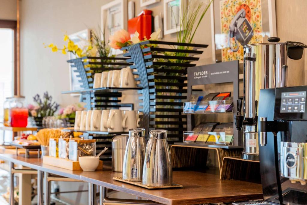 a coffee shop with a counter top with coffeeutes at Hilton Bournemouth in Bournemouth