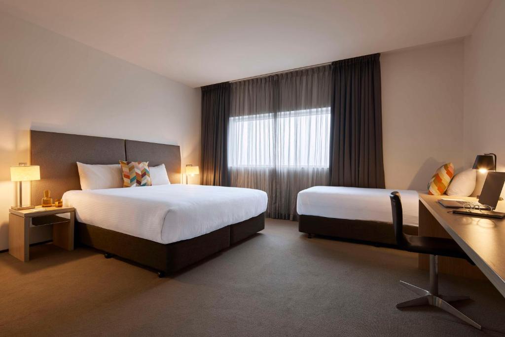a hotel room with two beds and a window at Atura Dandenong in Dandenong