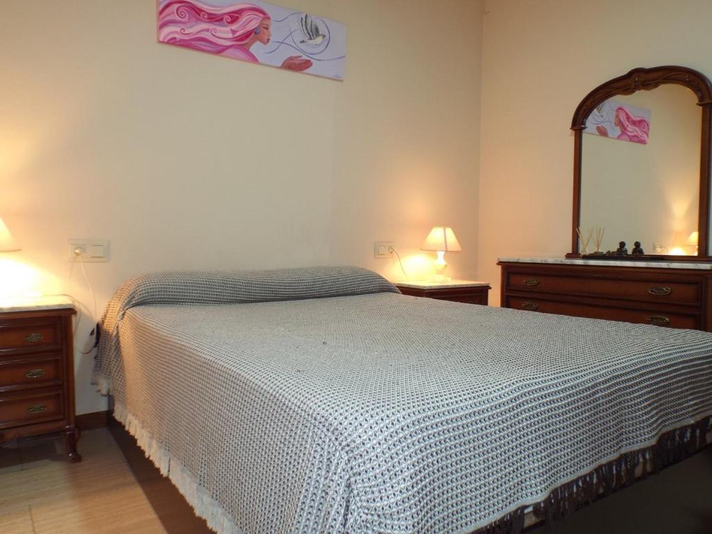 - une chambre avec un lit, deux commodes et un miroir dans l'établissement Casa Paco, à Luque