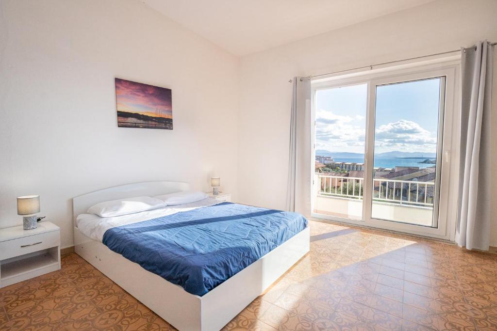 a white bedroom with a bed and a large window at "Tramontana" vista mare - 300m dalla spiaggia in Golfo Aranci