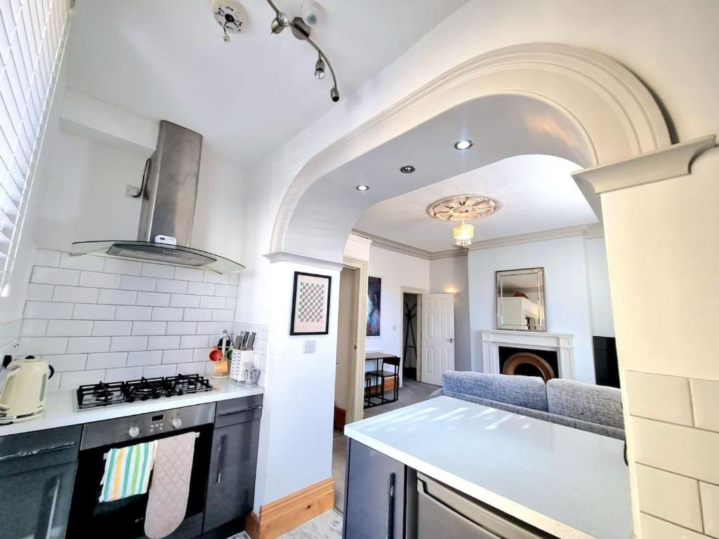 a kitchen and living room with a stove top oven at Entire Apartment by City Centre & Harbourside in Bristol