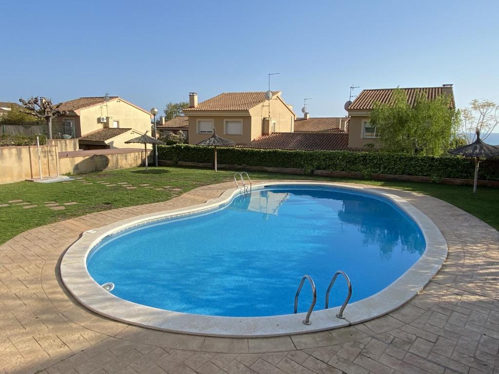 una gran piscina azul en un patio en TarracoHomes-TH138 Townhouse Altafulla cerca del Castillo en Altafulla