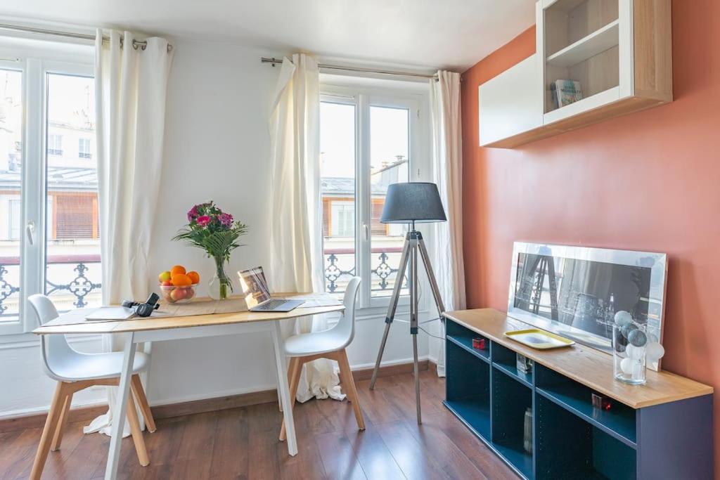 a room with a desk with a computer and a window at Comfortable flat - Montparnasse in Paris