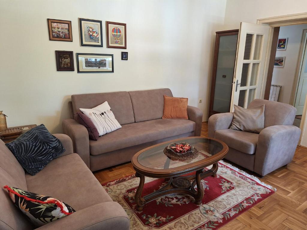 a living room with two couches and a coffee table at Apartment Music-center, in the center of Podgorica in Podgorica