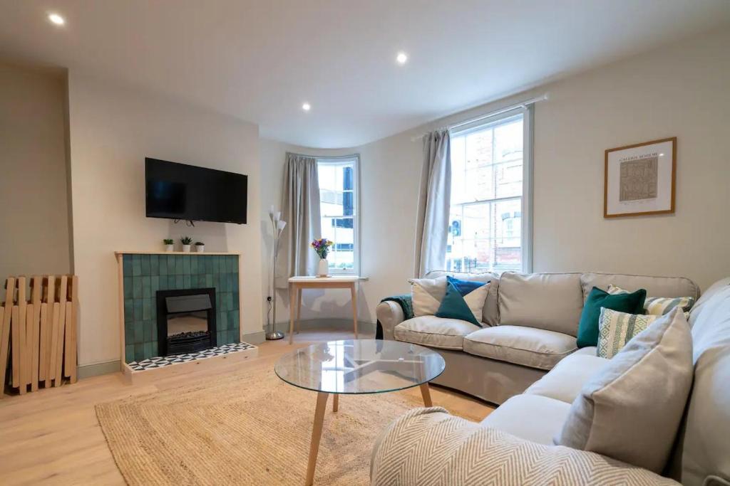 a living room with a couch and a fireplace at Pass the Keys Stylish Grade II listed house in Cheltenham