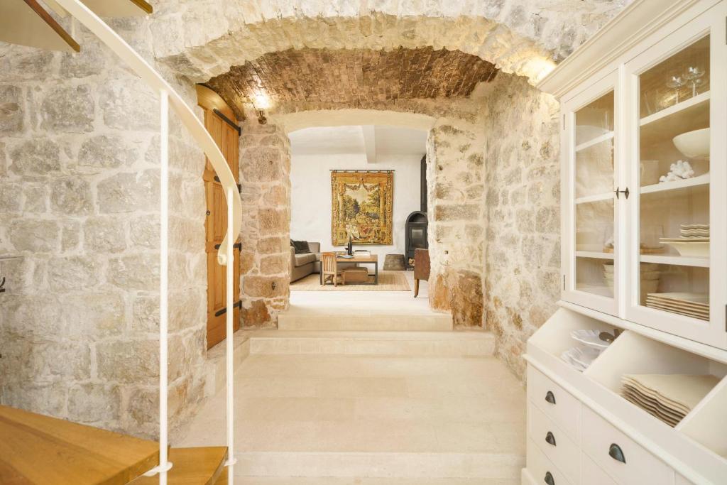 a hallway in a house with a stone wall at The Stone House in Zaton