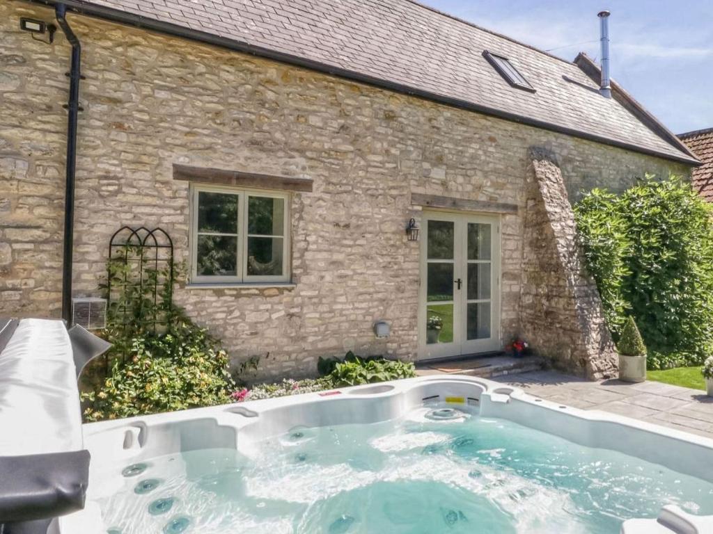 a swimming pool in front of a house at Braeburn - Uk38098 in Pilton
