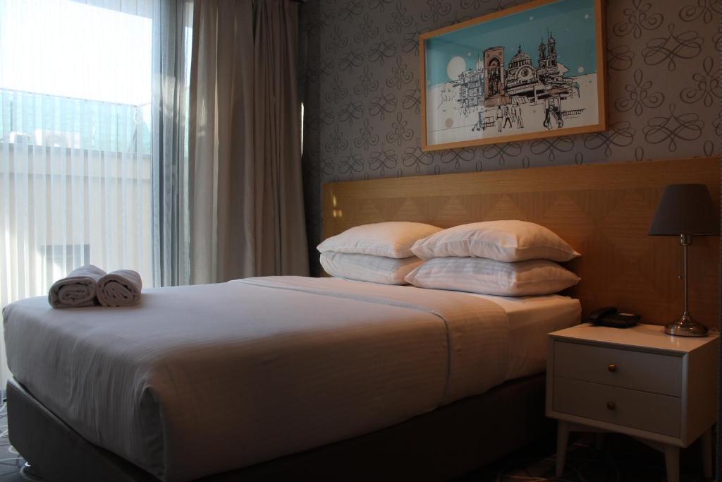 Postel nebo postele na pokoji v ubytování Four-G Hotel