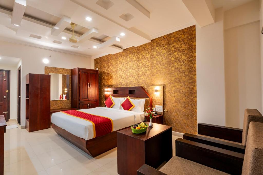 a hotel room with a bed and a couch at Daan Orchid Residency in Kottayam