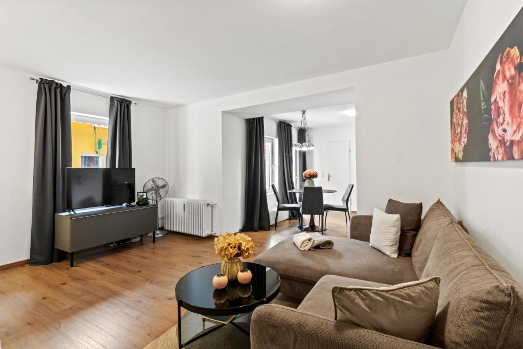 een woonkamer met een bank en een tv bij Stilvolles Zuhause mit Terrasse in Bruck an der Mur