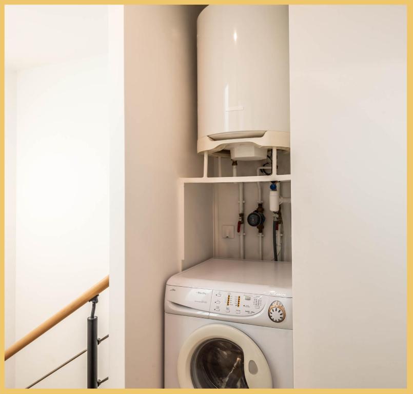 a small laundry room with a washer and dryer at Appart T3 Luxe Douvaine in Douvaine