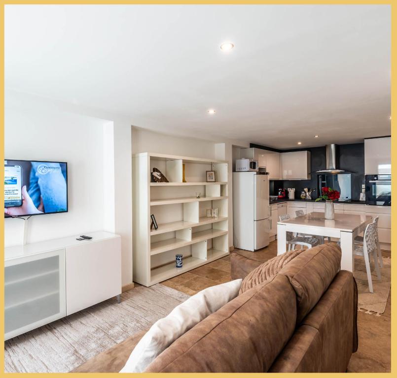 a living room with a couch and a kitchen at Appart T3 Luxe Douvaine in Douvaine