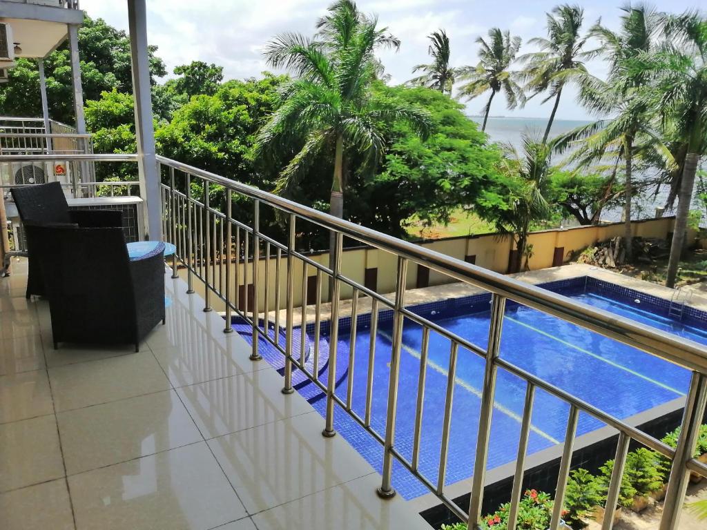 a balcony with a view of a swimming pool at BleVaMa Ocean View Home in Dar es Salaam