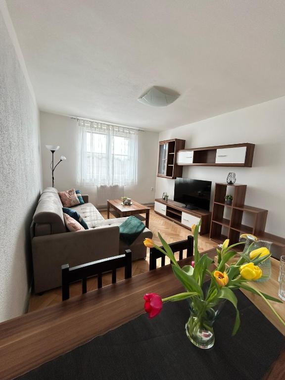 a living room with a couch and a table at Apartmán Žižka in Frymburk