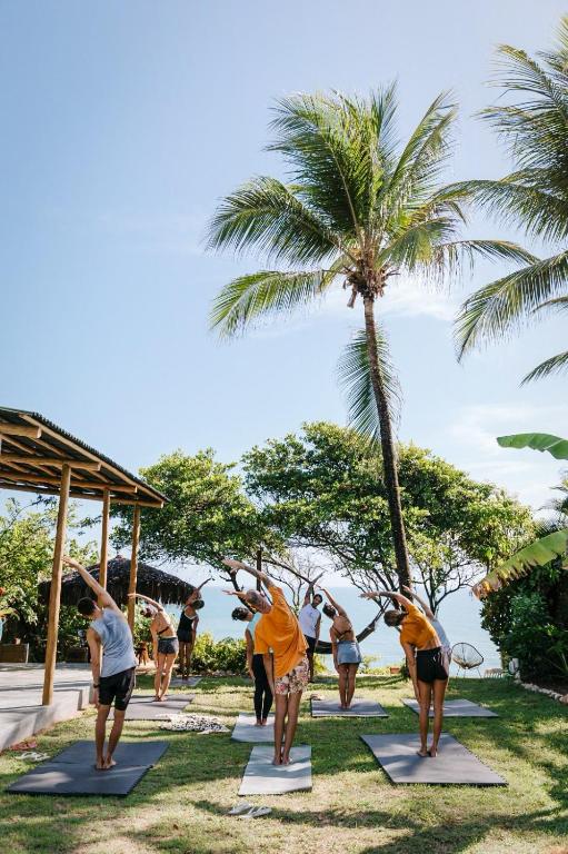 a group of people doing yoga at the beach at CASA VIDASURF in Pipa