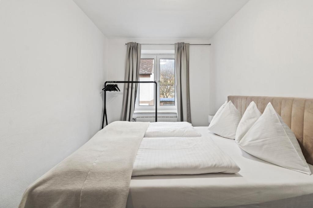 a bed with white sheets and pillows in a bedroom at Exklusive Unterkunft in RedBull-Ringnähe in Fohnsdorf