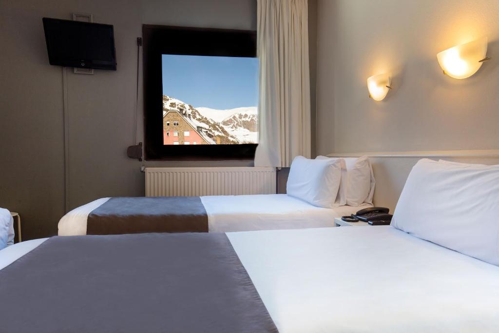 Postel nebo postele na pokoji v ubytování Hotel Camellot by Nexta