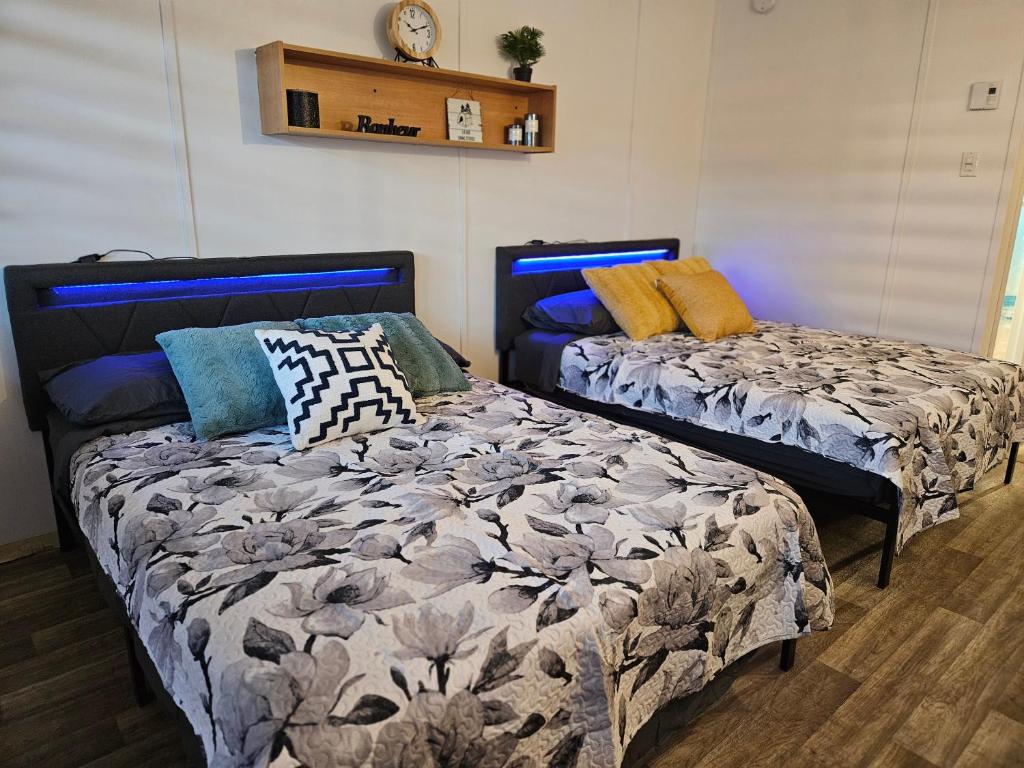 a bedroom with two beds with pillows on it at Parc Octopus in Desbiens