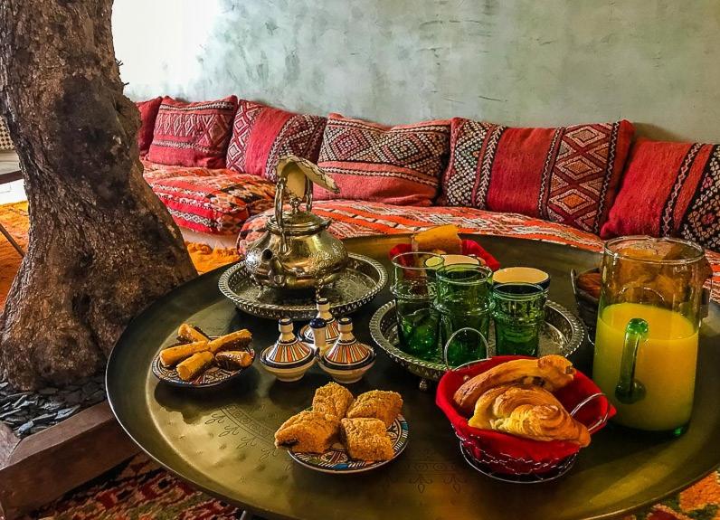 a table with plates of food and drinks on it at Riad SPA &quot;Les Portes de l&#39;Orient&quot; TOURS in Tours