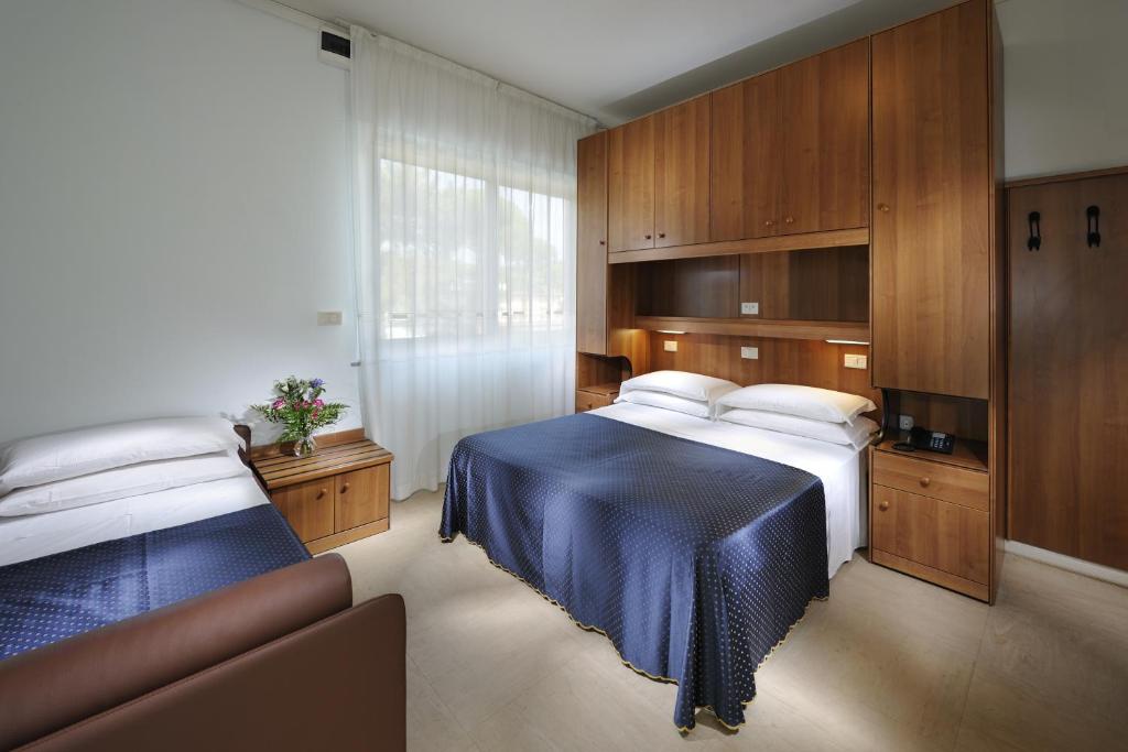 Postel nebo postele na pokoji v ubytování Hotel Mimosa