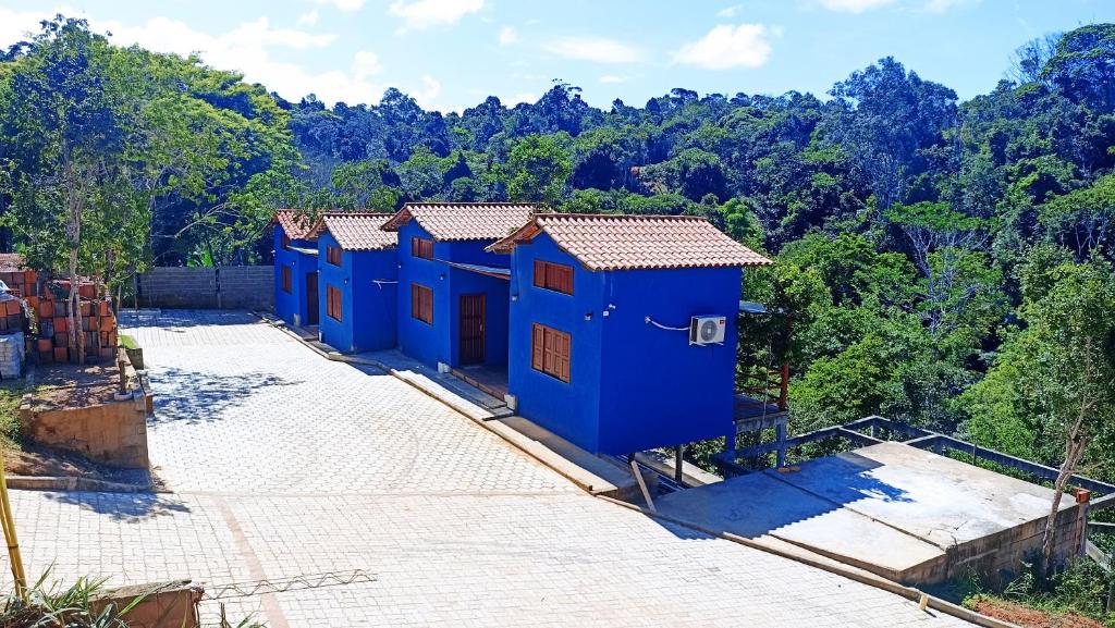 an overhead view of a row of blue huts at Recanto Fiel in Itacaré