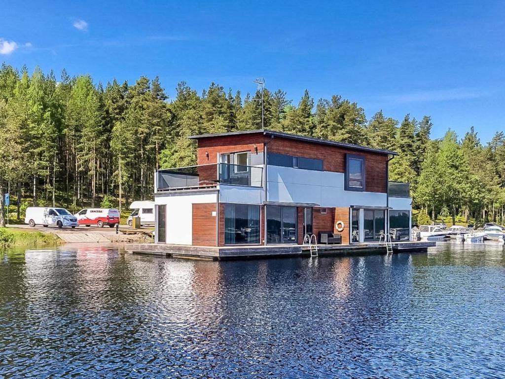 a house on a dock on a body of water at Holiday Home Villa joutseno by Interhome in Imatra