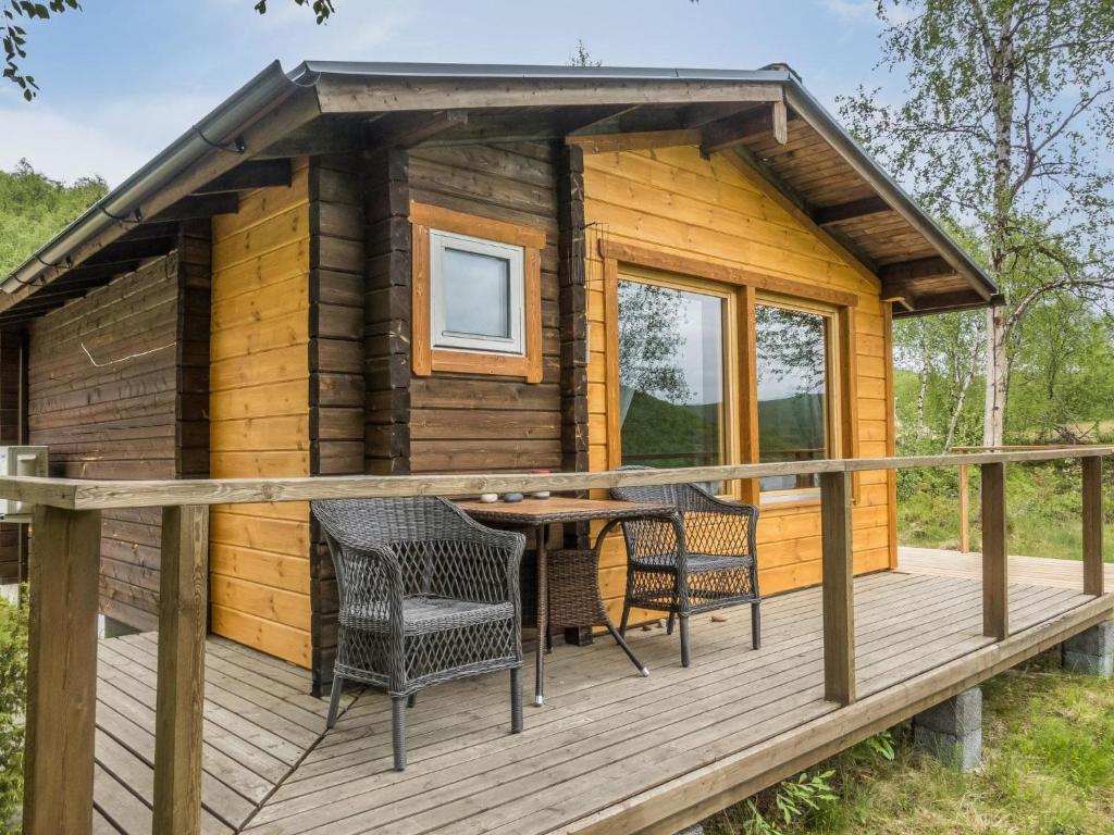 a cabin with a table and chairs on a deck at Holiday Home Nilla 3 by Interhome in Utsjoki