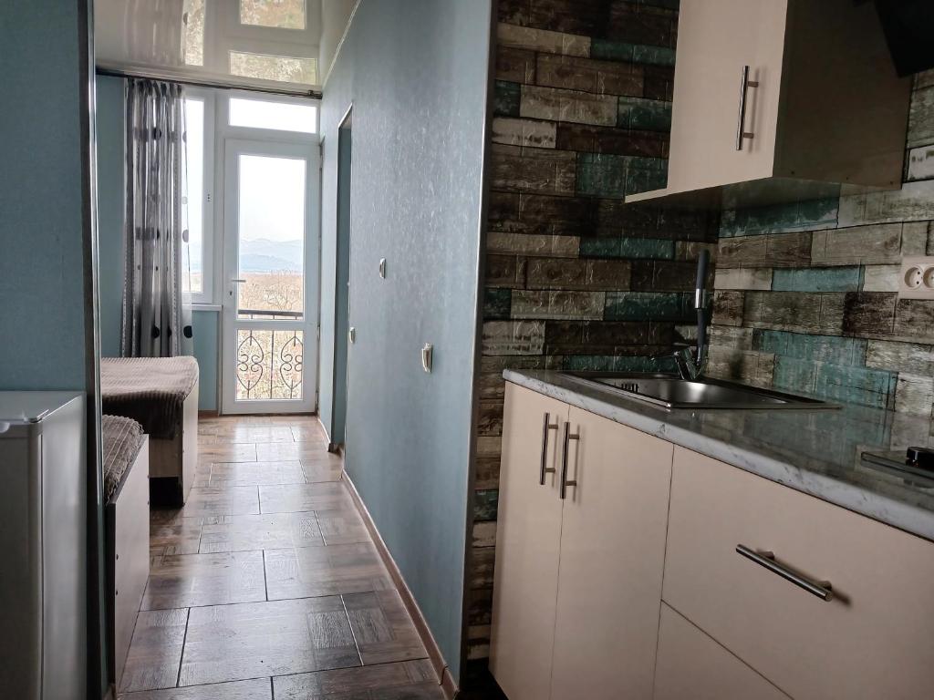 a kitchen with a sink and a counter top at Hotel Kobuleti in K'obulet'i
